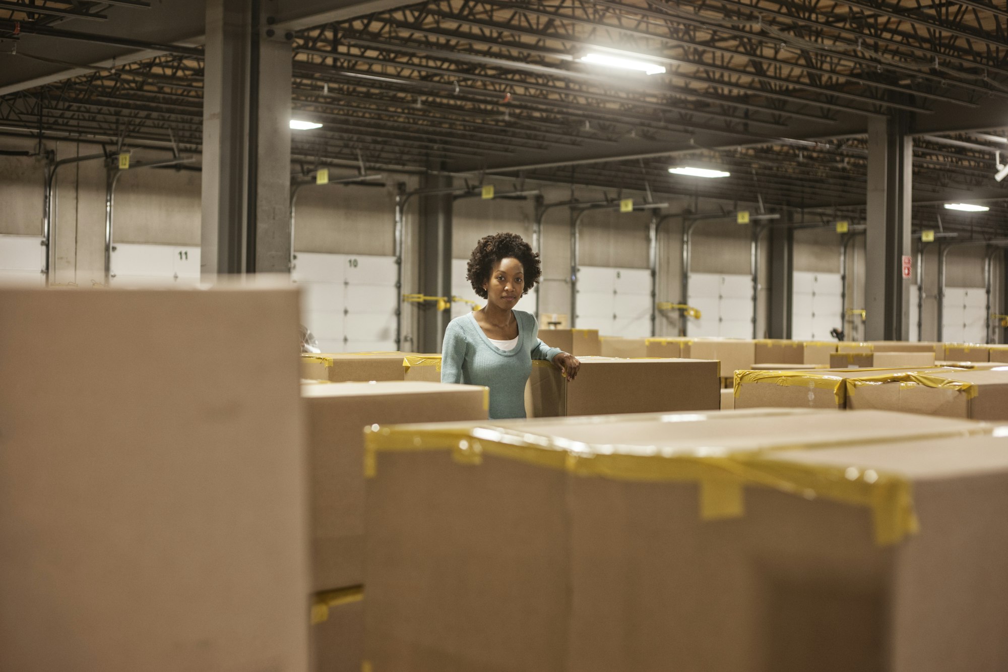 Portrait of an African American female warehouse worker in a large distribution warehouse with