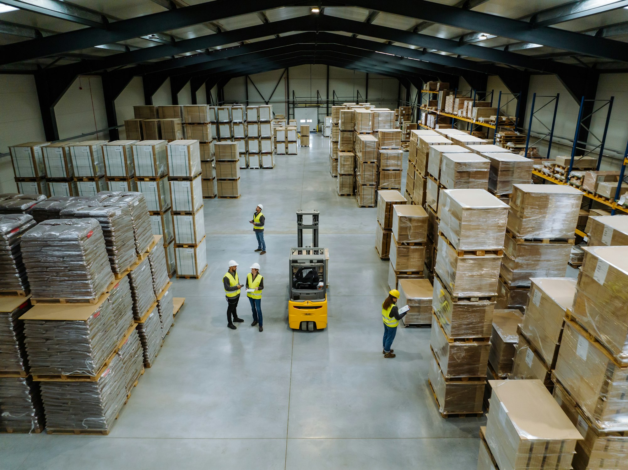 Top view of warehouse workers in warehouse. Team of warehouse workers preparing products for